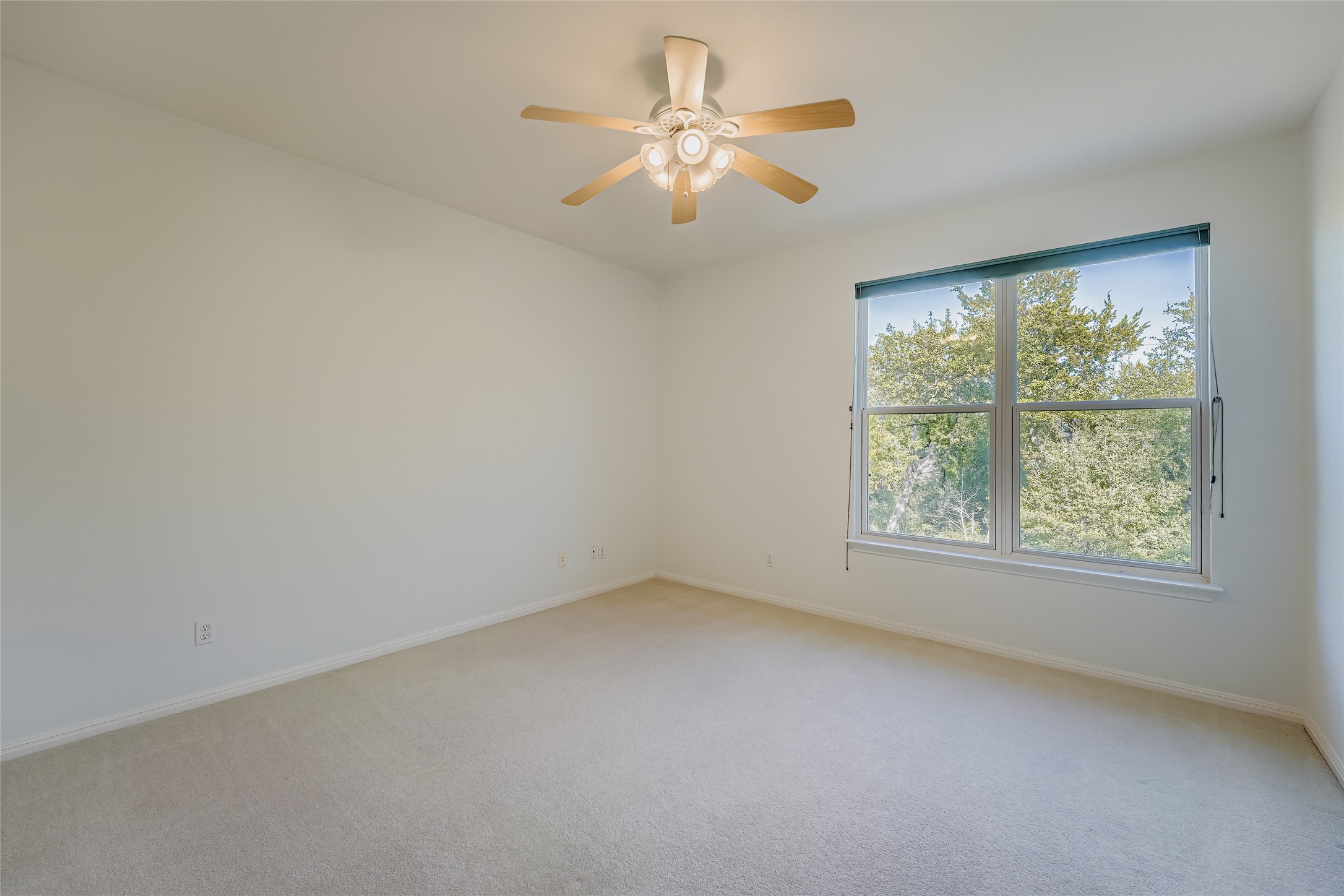 8204 Texas Plume Road Austin, TX 78759 - Photo 30 of 40 Empty room featuring light colored carpet and a ceiling fan