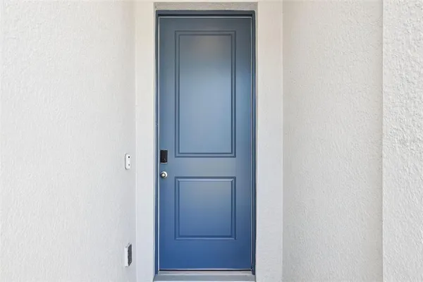 a view of kitchen with kitchen island sink and refrigerator