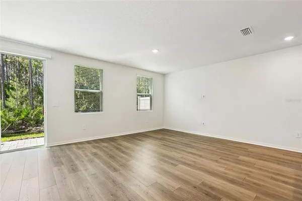 a view of a kitchen with sink and wooden floor