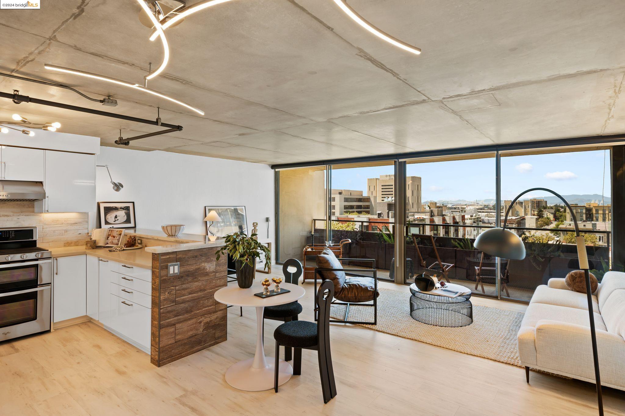 801 Franklin Street, Unit 824 Oakland, CA 94607 - Photo 1 of 1 a living room with furniture a rug and a large window
