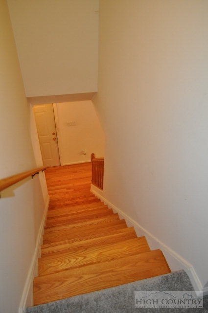 304 Green Knob Mountain Road Boone, NC 28607 - Photo 15 of 32 a bedroom with a bed and wooden floor