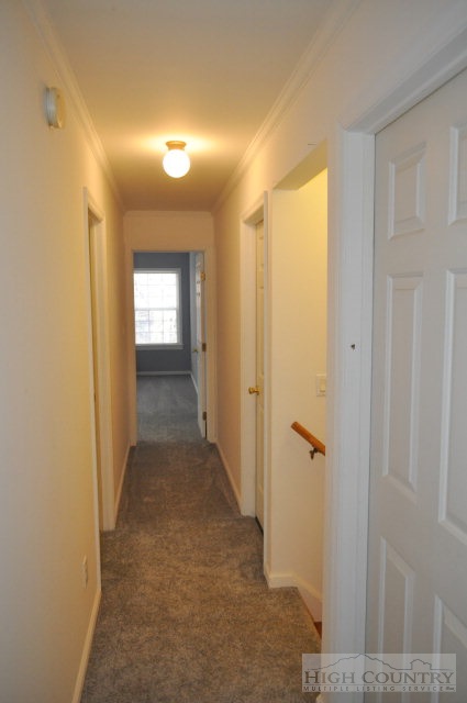 304 Green Knob Mountain Road Boone, NC 28607 - Photo 17 of 32 a view of a hallway with wooden floor and a bathroom