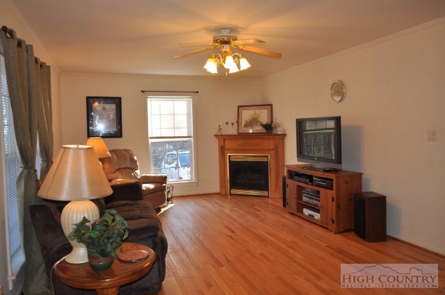 304 Green Knob Mountain Road Boone, NC 28607 - Photo 24 of 32 a living room with furniture a fireplace and a flat screen tv