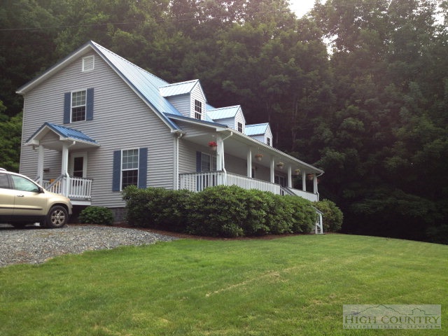 304 Green Knob Mountain Road Boone, NC 28607 - Photo 26 of 32 a front view of a house with a garden
