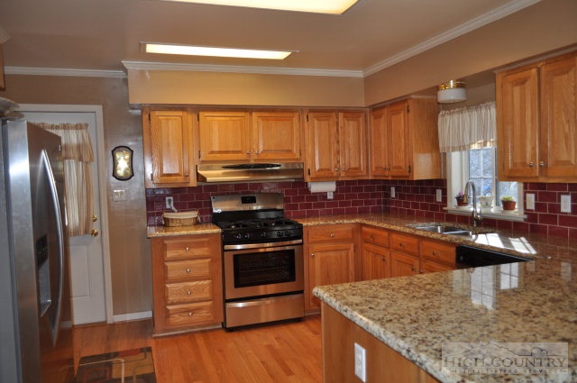 304 Green Knob Mountain Road Boone, NC 28607 - Photo 32 of 32 a kitchen with stainless steel appliances granite countertop a stove a sink and a refrigerator