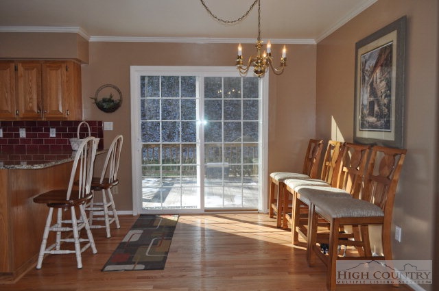 304 Green Knob Mountain Road Boone, NC 28607 - Photo 5 of 32 a view of a dining room with furniture and chandelier
