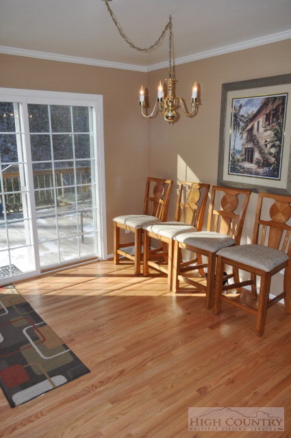 304 Green Knob Mountain Road Boone, NC 28607 - Photo 6 of 32 a view of a dining room with furniture a chandelier and wooden floor