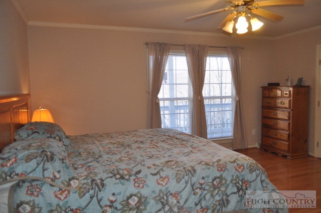 304 Green Knob Mountain Road Boone, NC 28607 - Photo 8 of 32 a bedroom with a bed and a flat tv screen on dresser