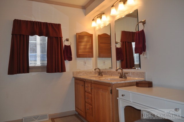 304 Green Knob Mountain Road Boone, NC 28607 - Photo 10 of 32 a bathroom with a sink and a mirror