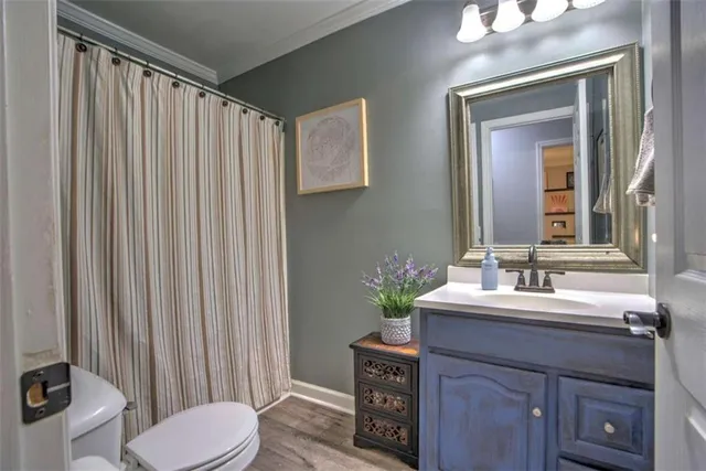 a bathroom with a sink vanity mirror and toilet