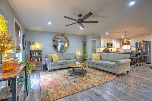 a living room with furniture a rug and a clock