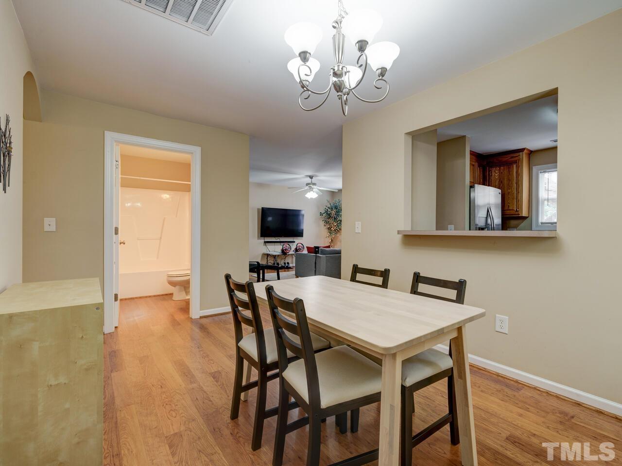 2221 Mountain Mist Court, Unit 101 Raleigh, NC 27603 - Photo 12 of 31 a view of a dining room with furniture and wooden floor
