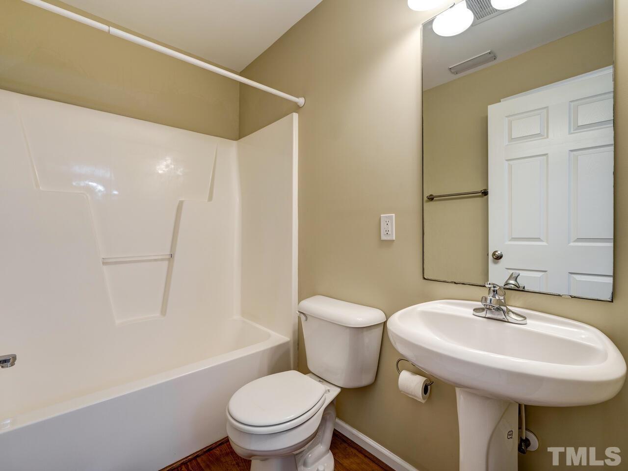 2221 Mountain Mist Court, Unit 101 Raleigh, NC 27603 - Photo 13 of 31 a bathroom with a sink a toilet and shower