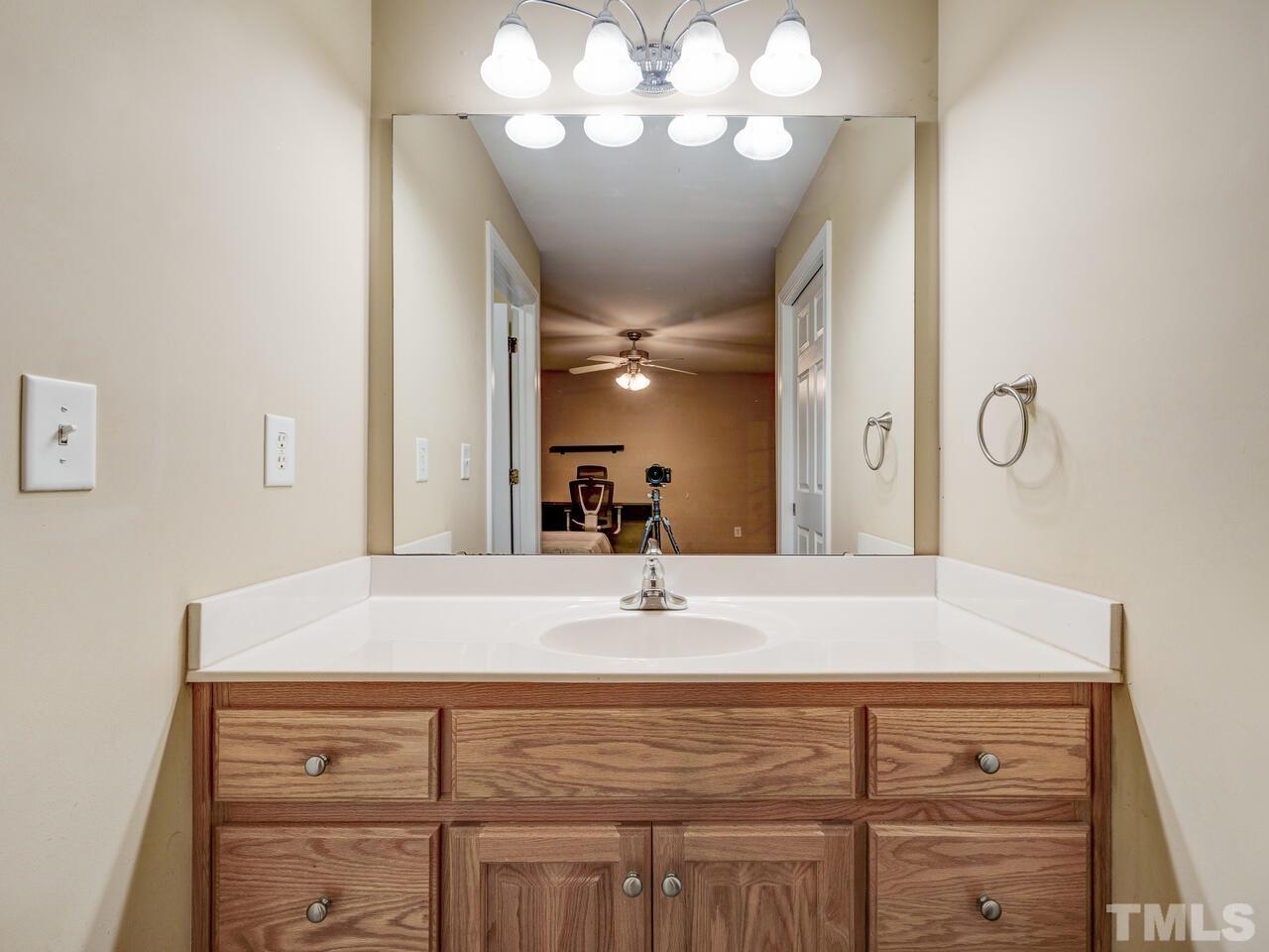 2221 Mountain Mist Court, Unit 101 Raleigh, NC 27603 - Photo 22 of 31 a bathroom with a sink vanity and a mirror