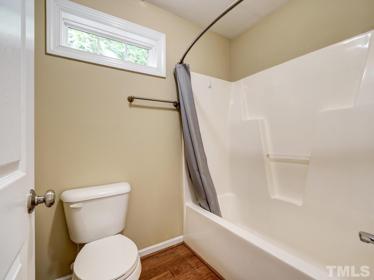 2221 Mountain Mist Court, Unit 101 Raleigh, NC 27603 - Photo 23 of 31 a white toilet sitting next to a bath tub