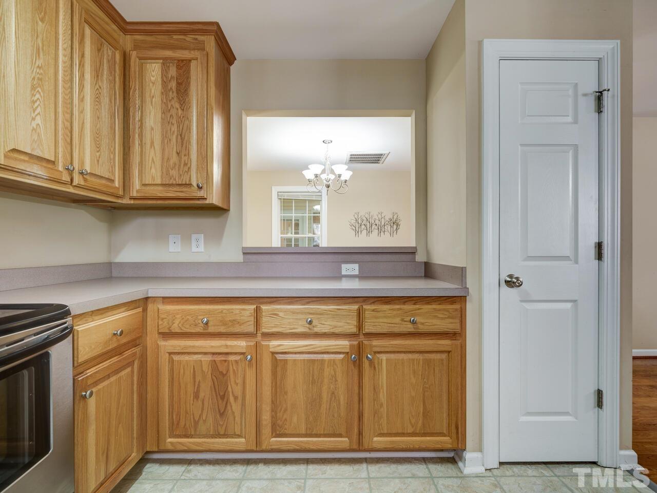 2221 Mountain Mist Court, Unit 101 Raleigh, NC 27603 - Photo 8 of 31 a view of a kitchen with granite countertop white cabinets and a wooden floor