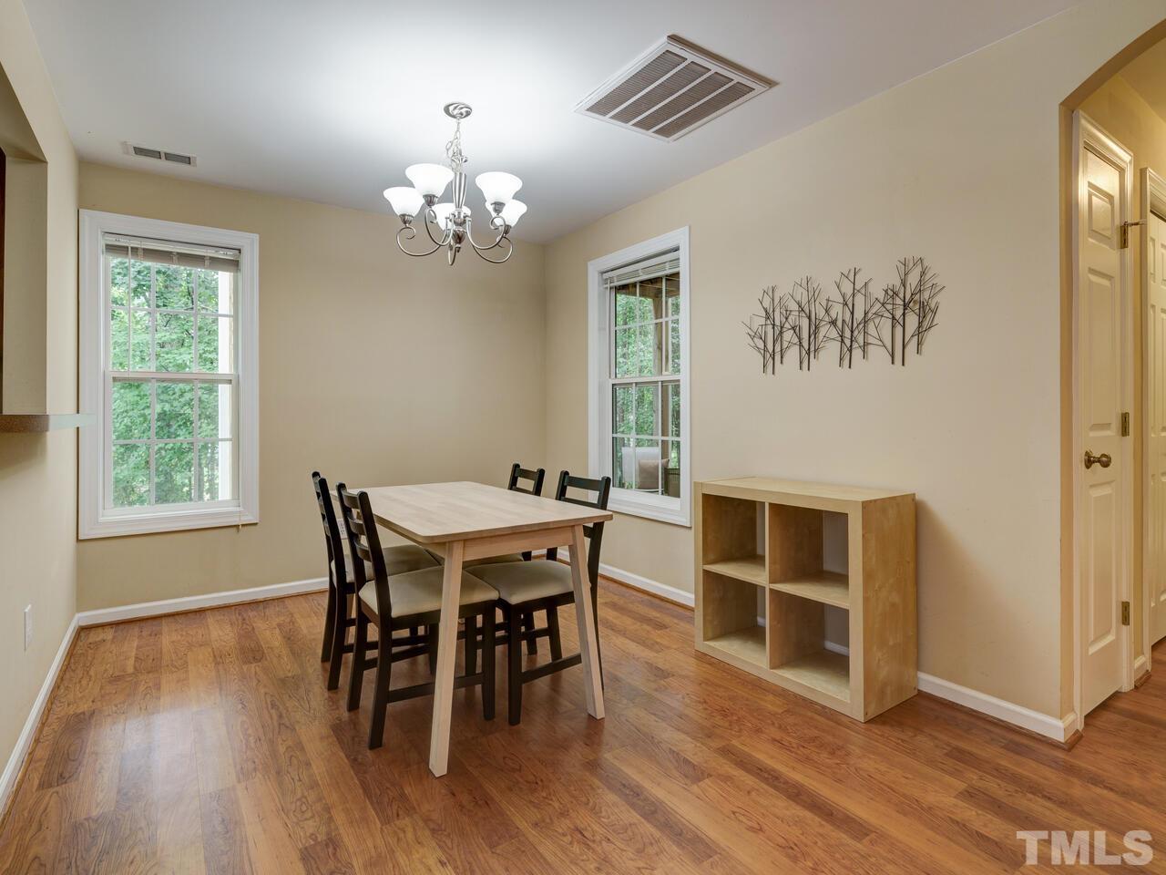 2221 Mountain Mist Court, Unit 101 Raleigh, NC 27603 - Photo 10 of 31 a view of a dining room with furniture and wooden floor