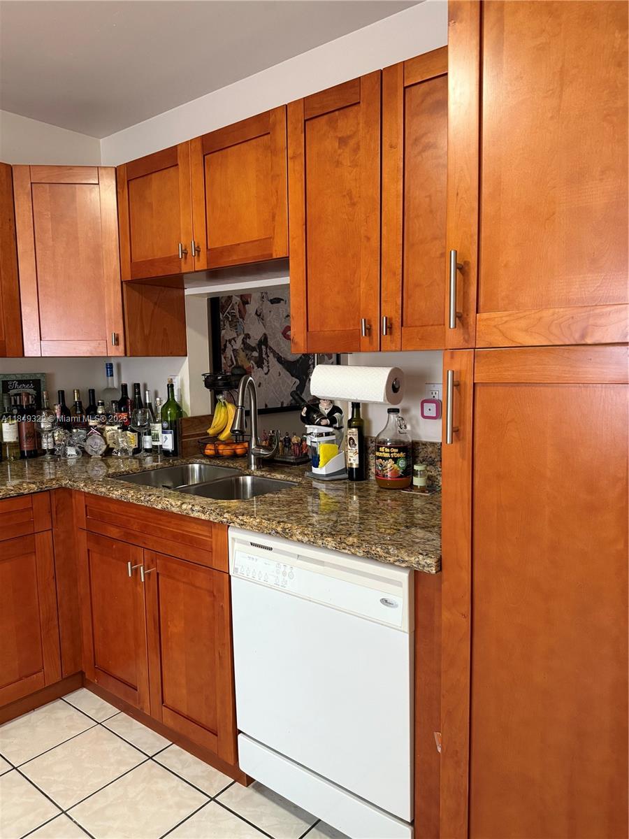 13402 Southwest 116th Place Miami, FL 33176 - Photo 15 of 16 a kitchen with stainless steel appliances granite countertop a sink and a window