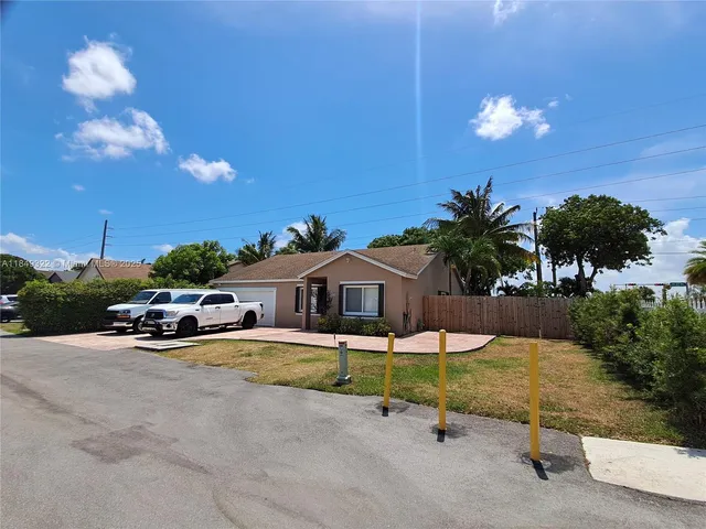 a swimming pool with outdoor seating and yard