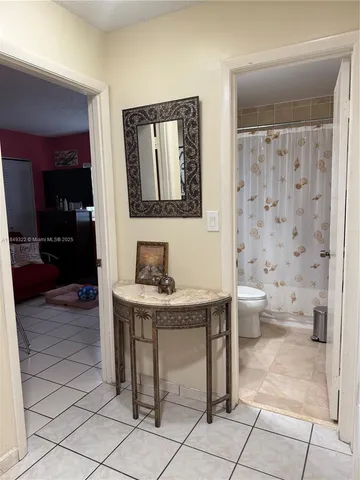 a bathroom with a toilet a sink and a mirror