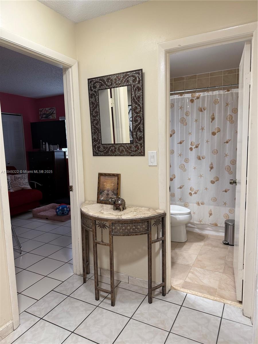 13402 Southwest 116th Place Miami, FL 33176 - Photo 6 of 16 a bathroom with a toilet a sink and a mirror