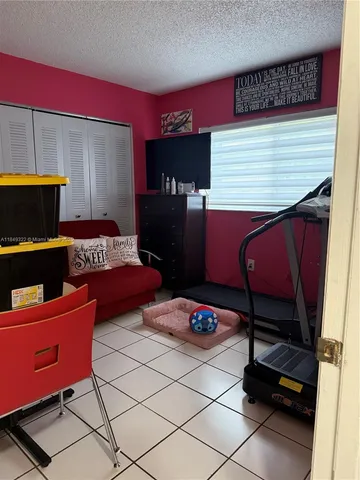 a bedroom with furniture and a lamp