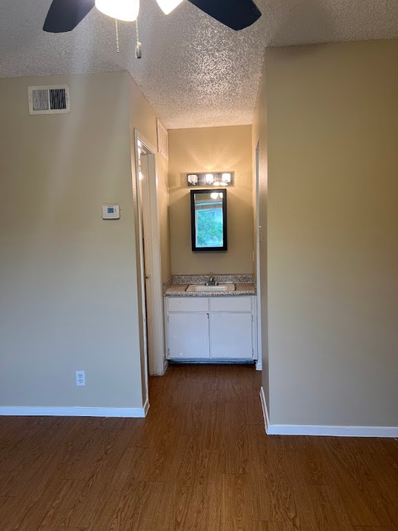 202 East 32nd Street, Unit 4 Austin, TX 78705 - Photo 6 of 10 Corridor with dark wood-style flooring and a textured ceiling