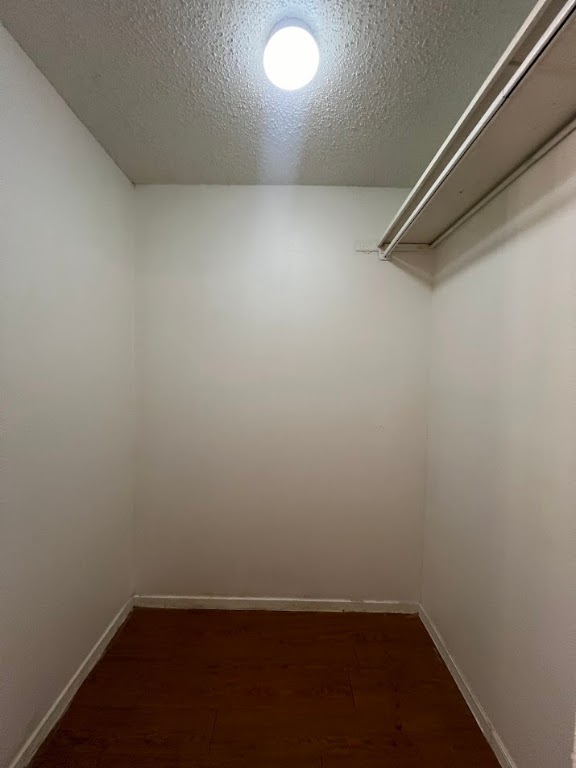 202 East 32nd Street, Unit 4 Austin, TX 78705 - Photo 7 of 10 Walk in closet with dark wood finished floors