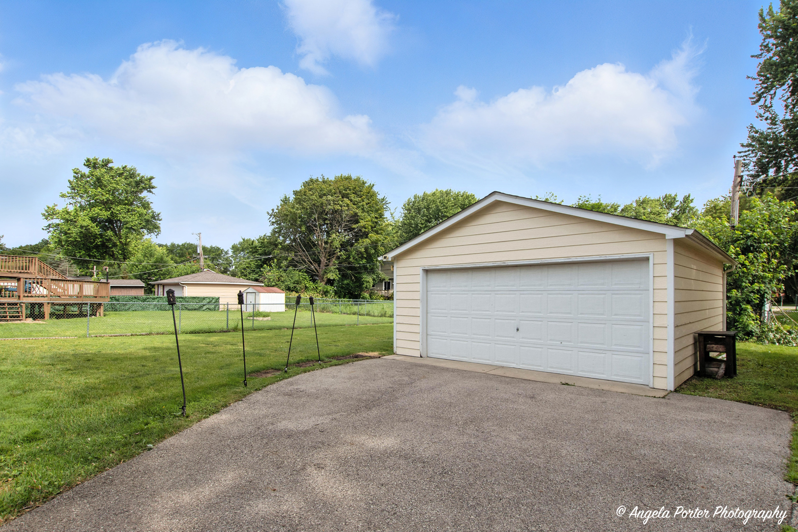 4420 Clearview Drive McHenry, IL 60050 - Photo 3 of 15 a view of a backyard with potted plants and a large tree