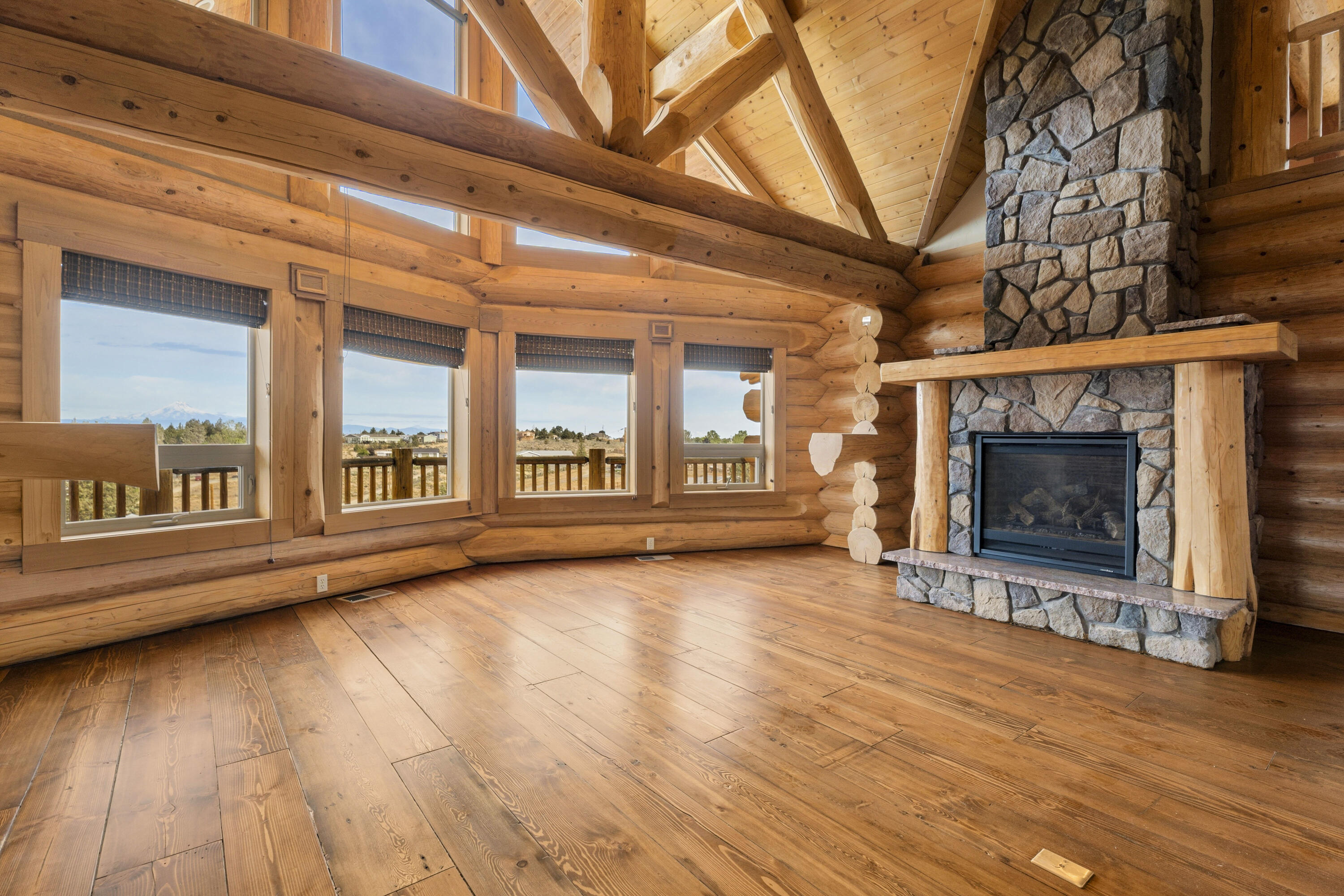 10739 Southwest Shad Road Terrebonne, OR 97760 - Photo 26 of 55 a view of an empty room with wooden floor fireplace and a window