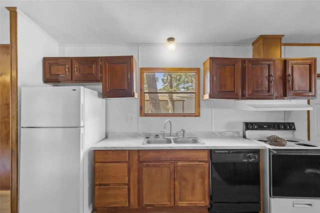 a kitchen with stainless steel appliances granite countertop a refrigerator sink and cabinets