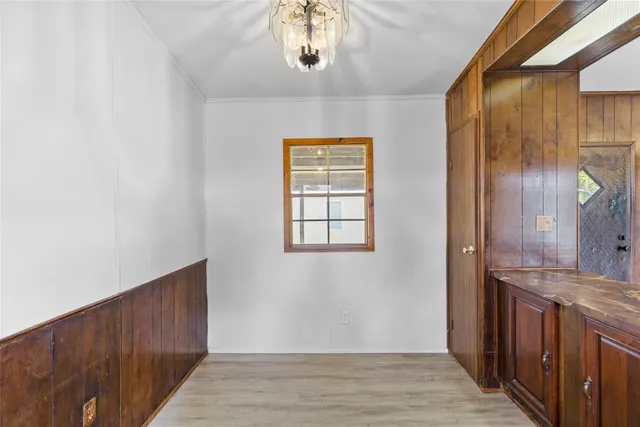a view of hallway with granite countertop wooden floor