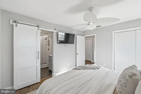 a bedroom with a bed and a chandelier