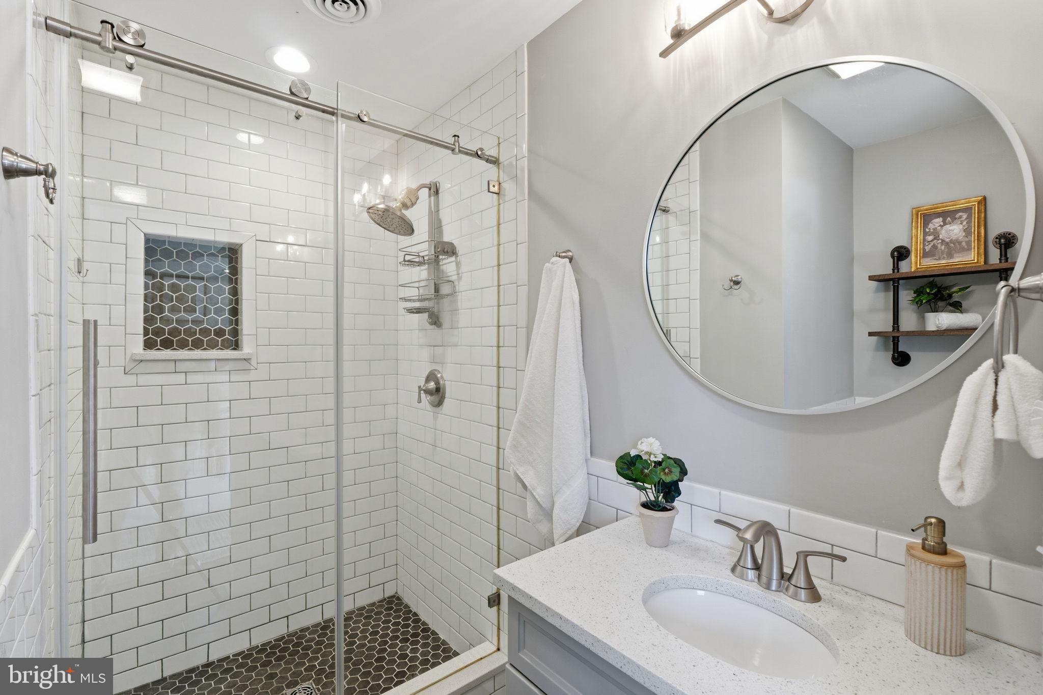 4231 Bartholows Road Mount Airy, MD 21771 - Photo 22 of 53 a bathroom with a sink a glass door shower and a mirror