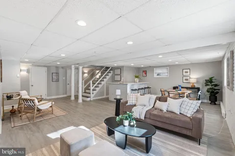 a living room with wooden floor and furniture