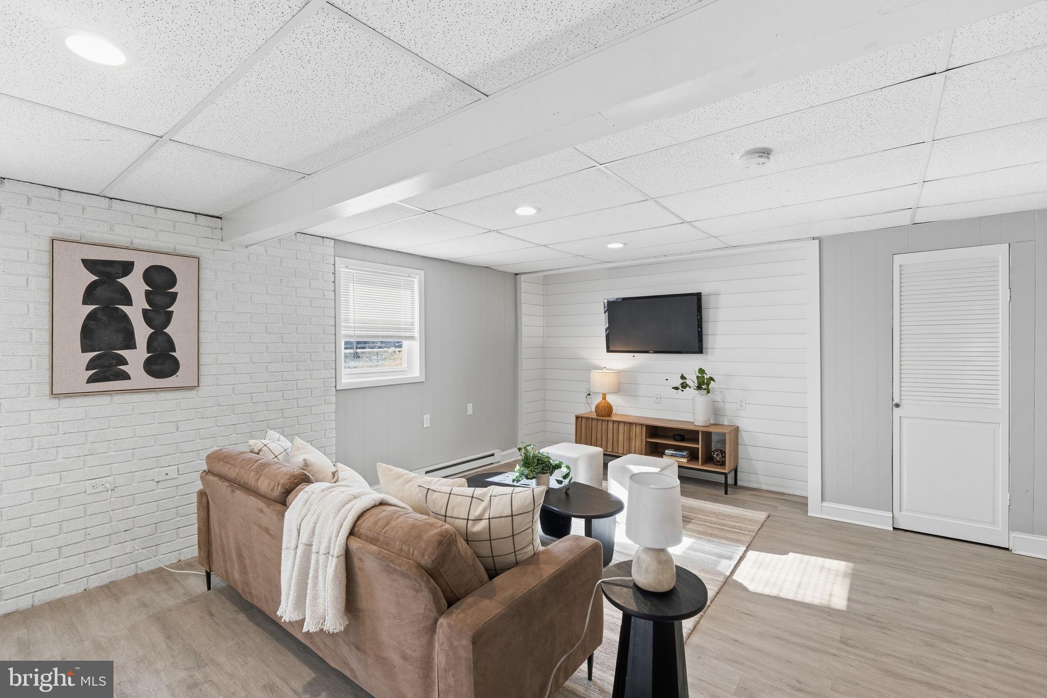 4231 Bartholows Road Mount Airy, MD 21771 - Photo 38 of 53 a living room with furniture and a flat screen tv