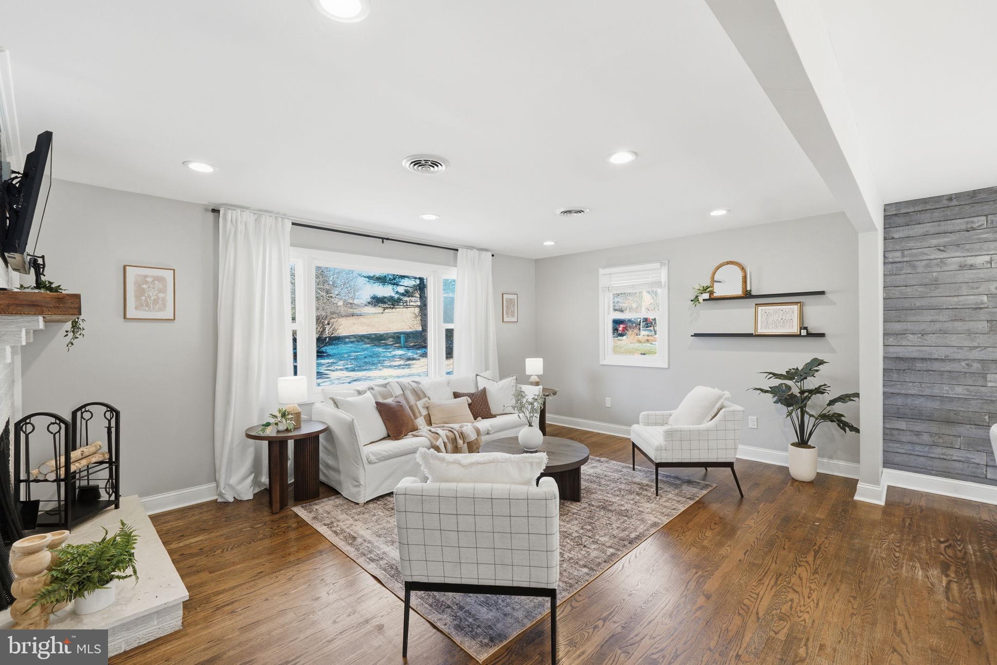4231 Bartholows Road Mount Airy, MD 21771 - Photo 5 of 53 a living room with furniture and wooden floor