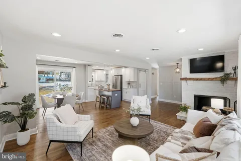 a living room with furniture fireplace and a flat screen tv