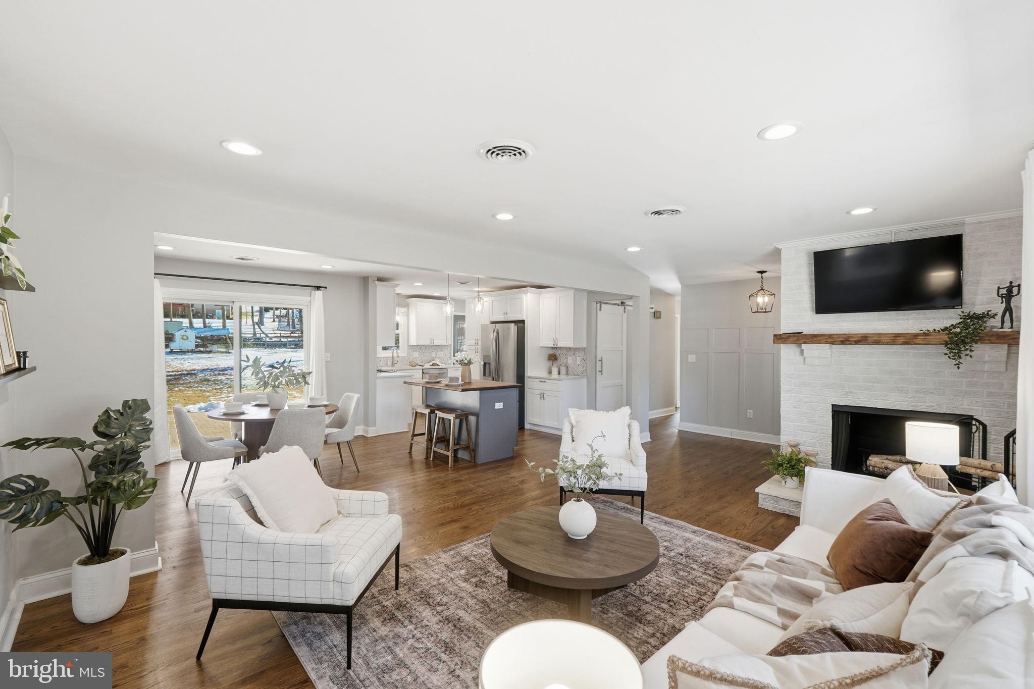 4231 Bartholows Road Mount Airy, MD 21771 - Photo 6 of 53 a living room with furniture fireplace and a flat screen tv
