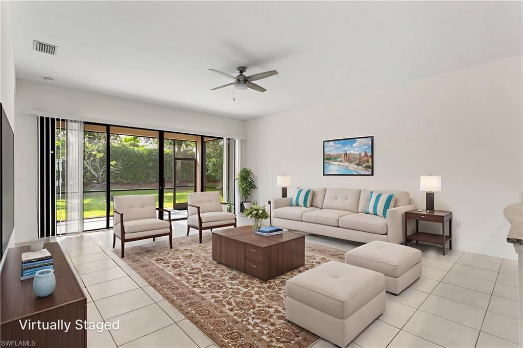 4486 Crimson Avenue Naples, FL 34119 - Photo 4 of 22 a living room with furniture and a large window