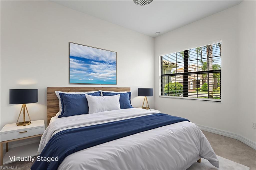 4486 Crimson Avenue Naples, FL 34119 - Photo 8 of 22 a bedroom with a large bed and a window