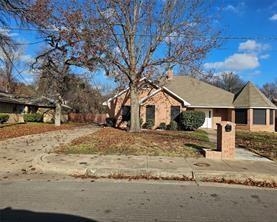 6530 Talbot Parkway Dallas, TX 75232 - Photo 1 of 18 a view of a white house with a yard with snow on the road