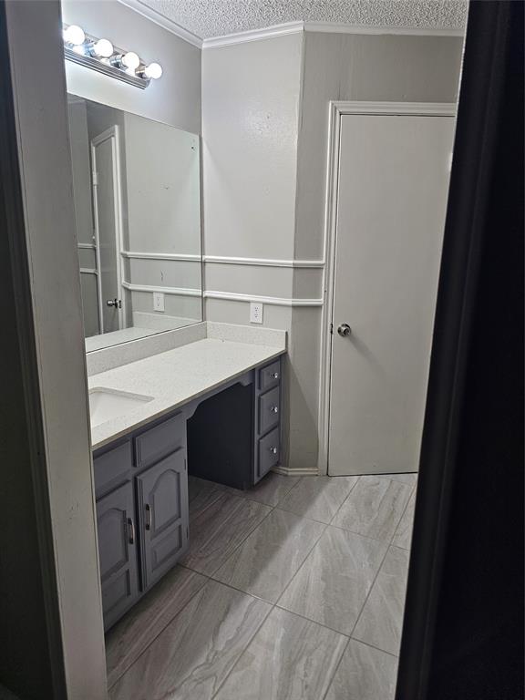6530 Talbot Parkway Dallas, TX 75232 - Photo 12 of 18 a bathroom with a sink vanity and a mirror