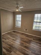 6530 Talbot Parkway Dallas, TX 75232 - Photo 15 of 18 an empty room with wooden floor and windows