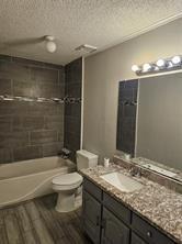 6530 Talbot Parkway Dallas, TX 75232 - Photo 17 of 18 a bathroom with a granite countertop sink toilet and shower