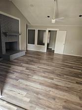 6530 Talbot Parkway Dallas, TX 75232 - Photo 4 of 18 a view of an empty room with wooden floor and a fireplace