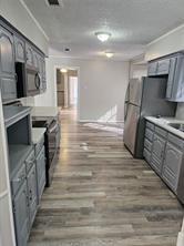 6530 Talbot Parkway Dallas, TX 75232 - Photo 7 of 18 a kitchen with stainless steel appliances granite countertop a stove and a refrigerator