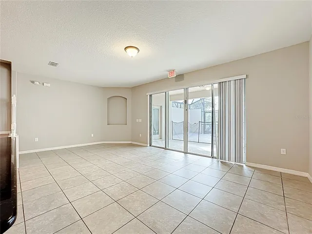 a view of kitchen with kitchen island granite countertop a refrigerator and a stove top oven
