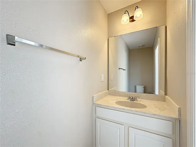 a white toilet sitting next to a white walls