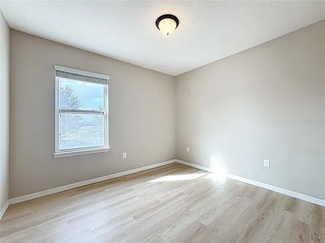 a view of a room with wooden floor and bathroom